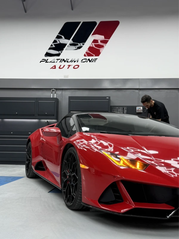 Red Lamborghini Huracán inside the Platinum One Auto workshop