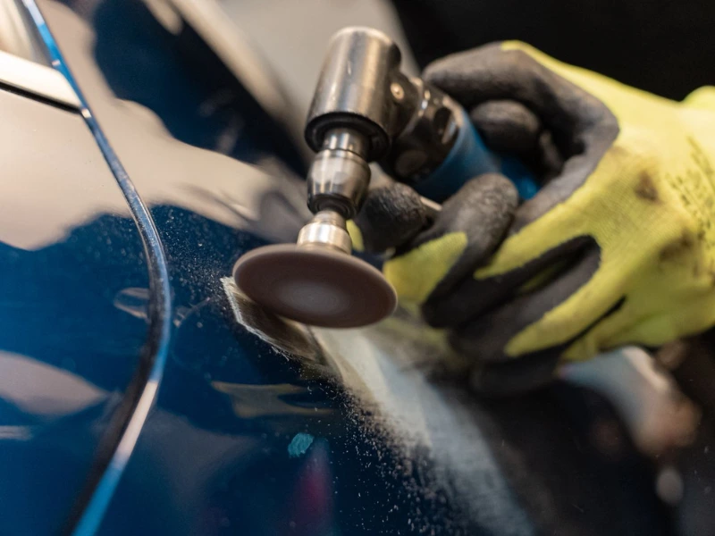 angle grinder being used for professional car body repairs
