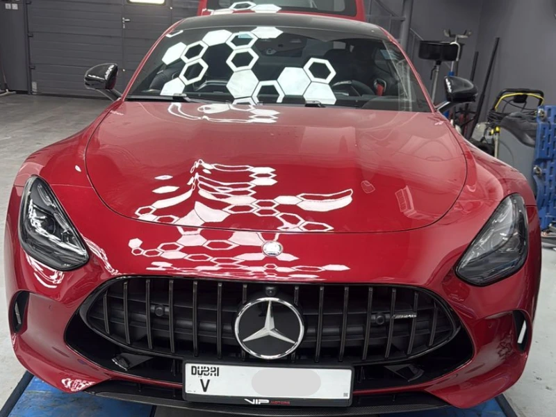 Red Mercedes-AMG GT Coupe in workshop close up